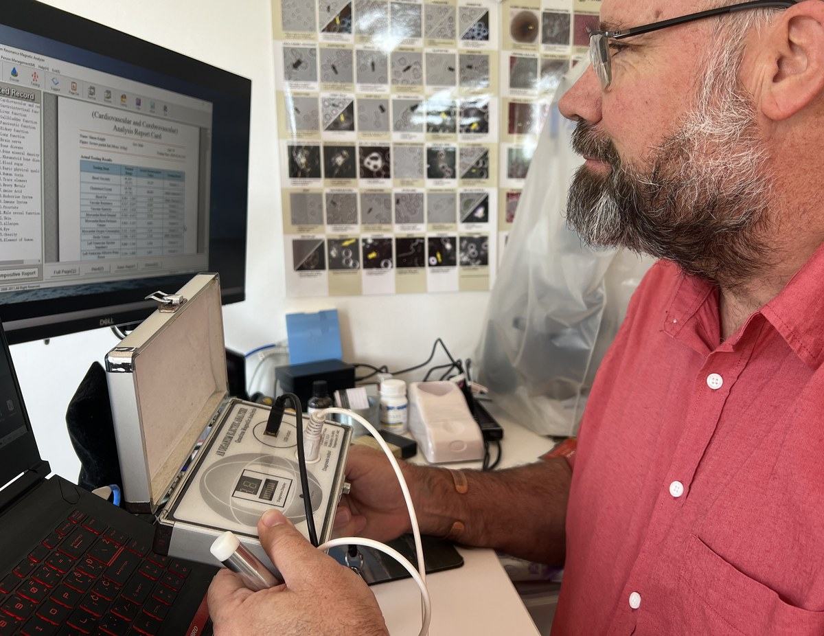 Quantum magnetic resonance scan in progress with the analysis report on screen